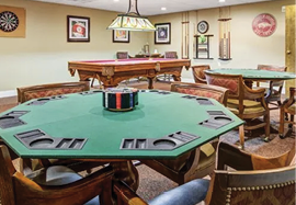 A room with a pool table and a dining table with chairs around it. AI generated content
