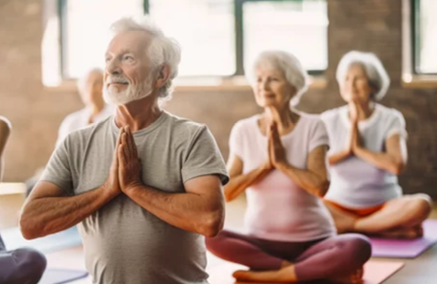 A group of elderly people are sitting on a mat, meditating and praying. AI generated content